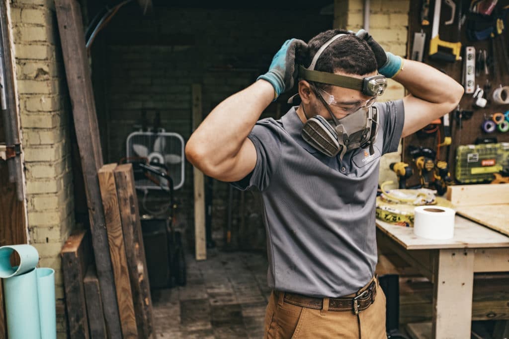 crawl space contractor preparing to install vapor barrier