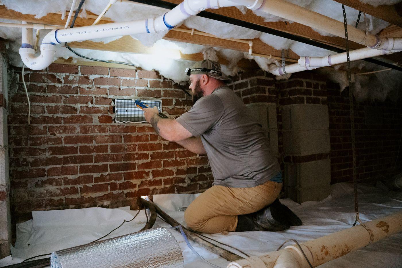 Crawlspace Medic crews at work under a home.
