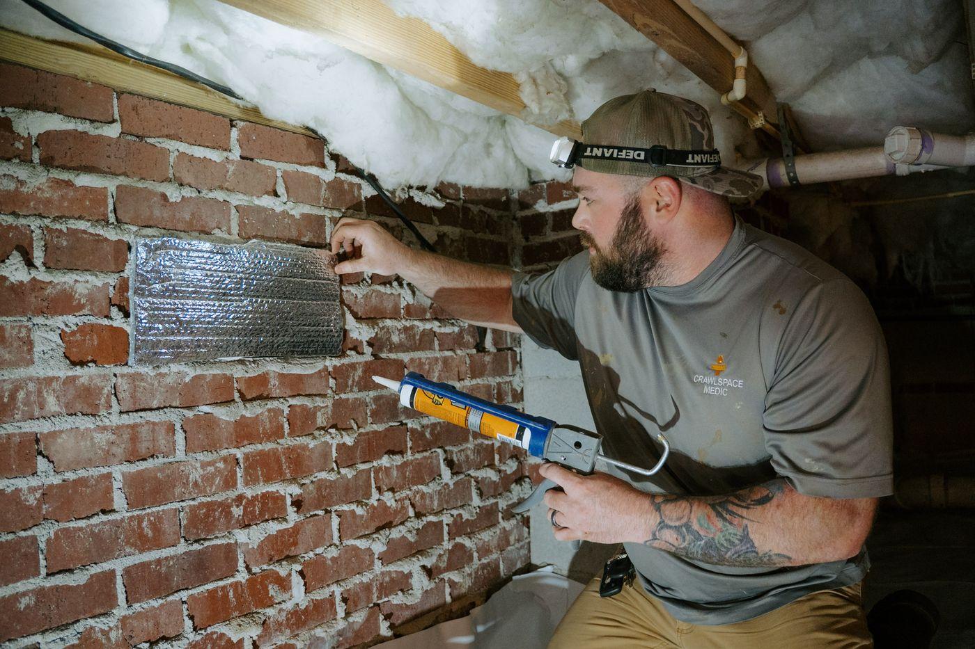 Crawlspace Medic crews at work under a home.