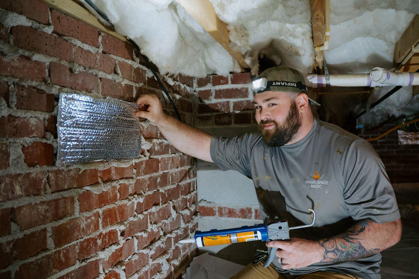 Crawlspace Medic crews at work under a home.