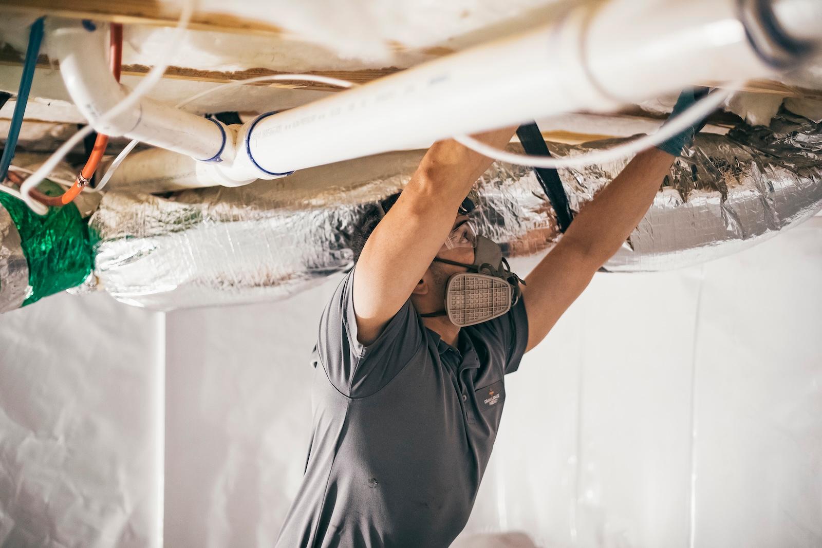 Crawlspace Medic crew at work under a home