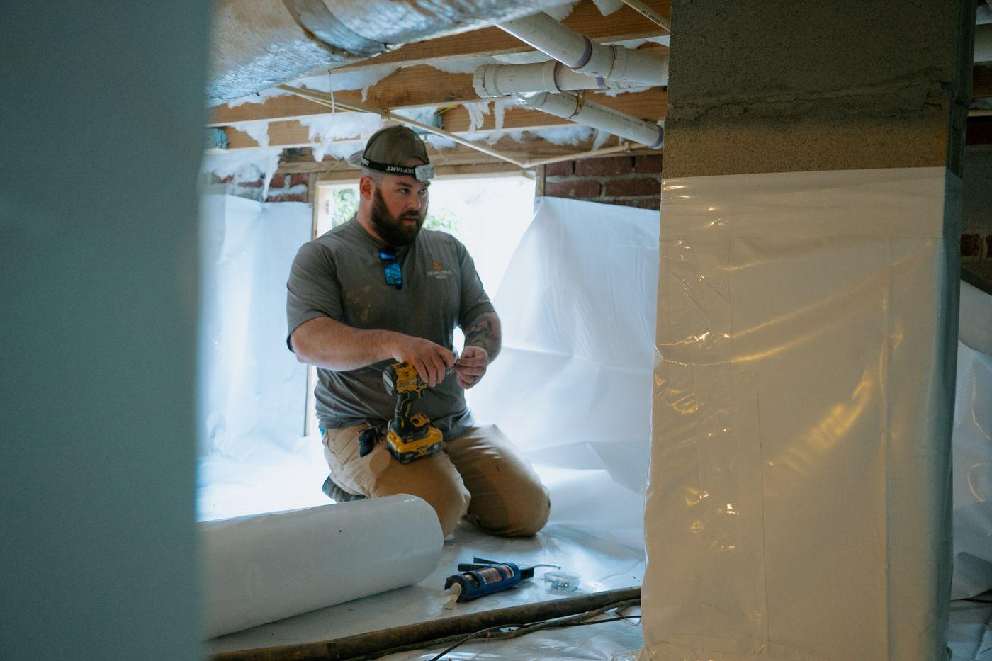 Crawlspace Medic crews at work under a home.