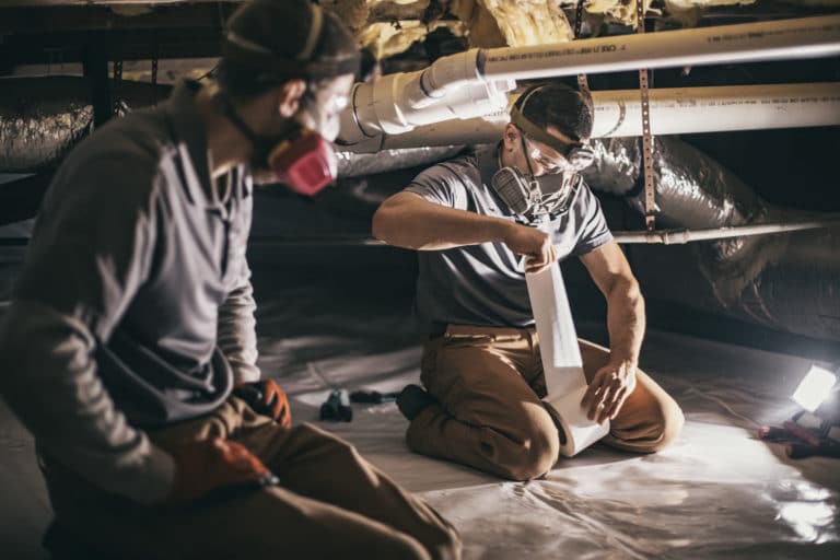 crawl space contractors installing vapor barrier