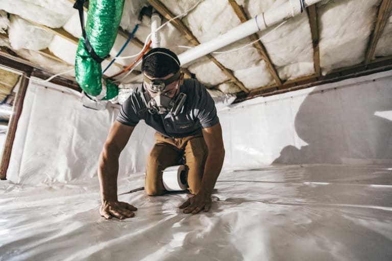 laying down a vapor barrier in a crawl space