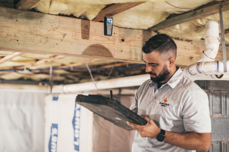 crawl space technician checking work for quality
