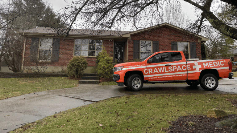 Crawlspace Medic Truck in front of a home