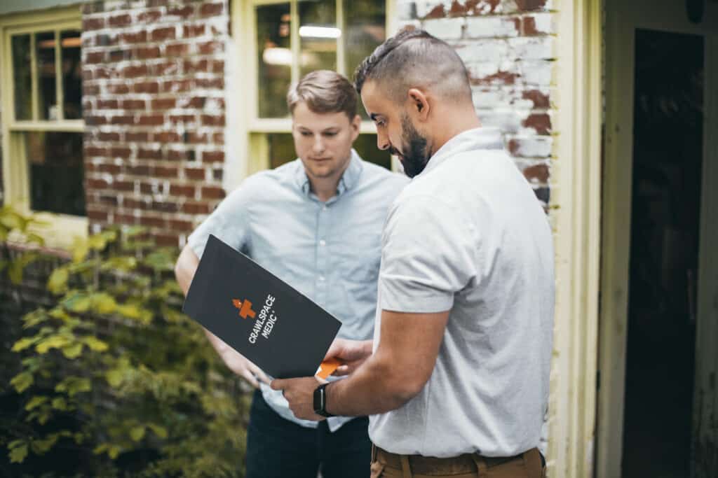 Crawlspace Medic inspector reviewing crawl space findings with Fredericksburg homeowner